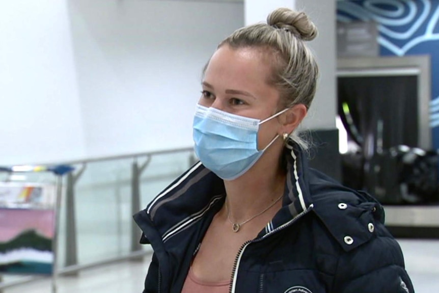 Headshot of a woman in side profile wearing a face mask at Perth Aiport.