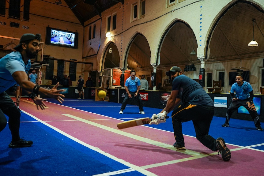 A game of cricket inside a church.