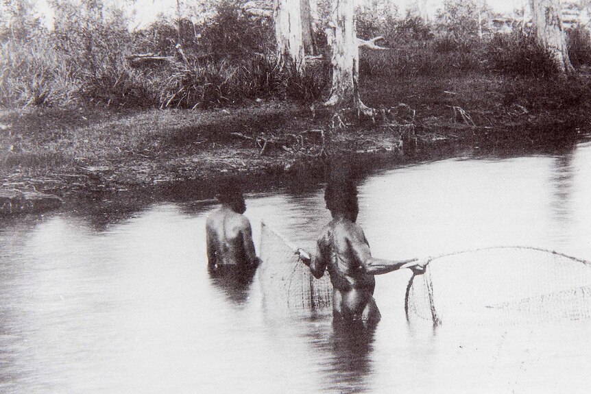 A page from a book shows two Aboriginal men using a tow-row to fish at Deception Bay in the 1890s.
