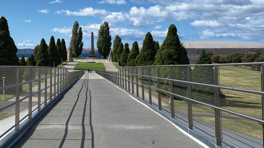 Graphic image of a walk way to cenotaph with a building on the right