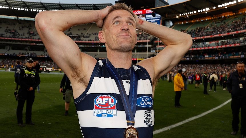 Joel Selwood wearing his AFL premiership medallion on the MCG after the grand final.