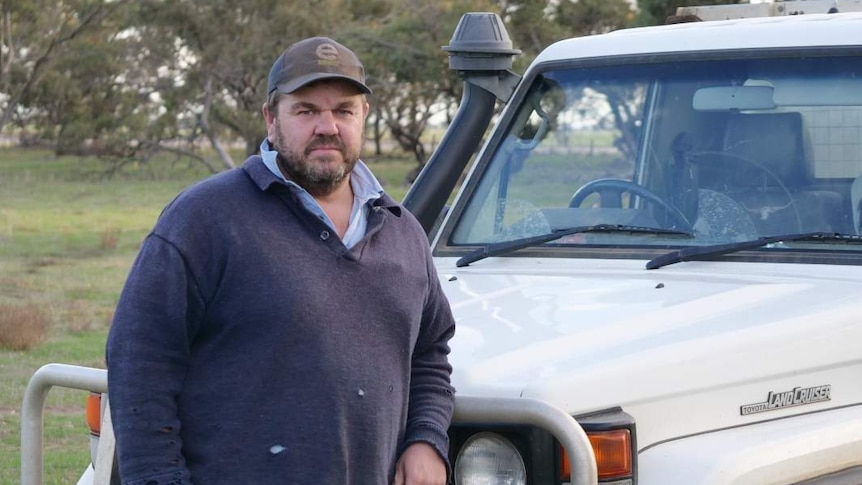 Man leaning on a ute.