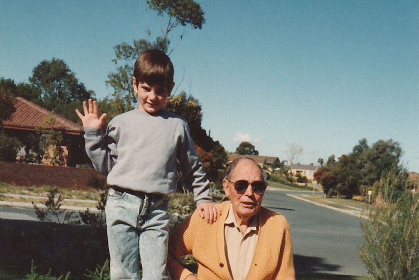 An old photo of a child with an older man.
