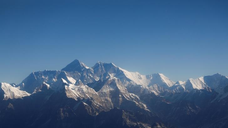 A landscape view of Mount Everest and other peaks of the Himalayan range.
