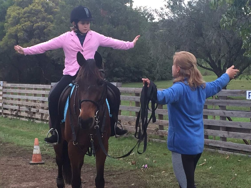 Daisy Brown riding horse Gunni with instructor Irina Aleksandrova watching on.