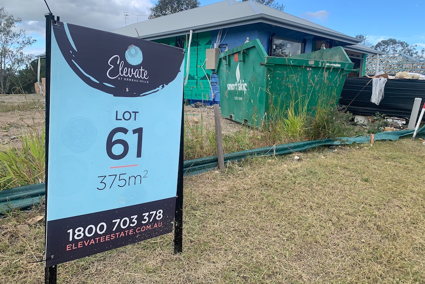 A blue 'Elevate at Ormeau Hills' sign outside an unfinished home