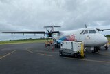Airport workers load up an Air Vanuatu plane.