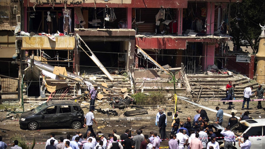 Egyptians gather at the site of a bomb in Cairo.