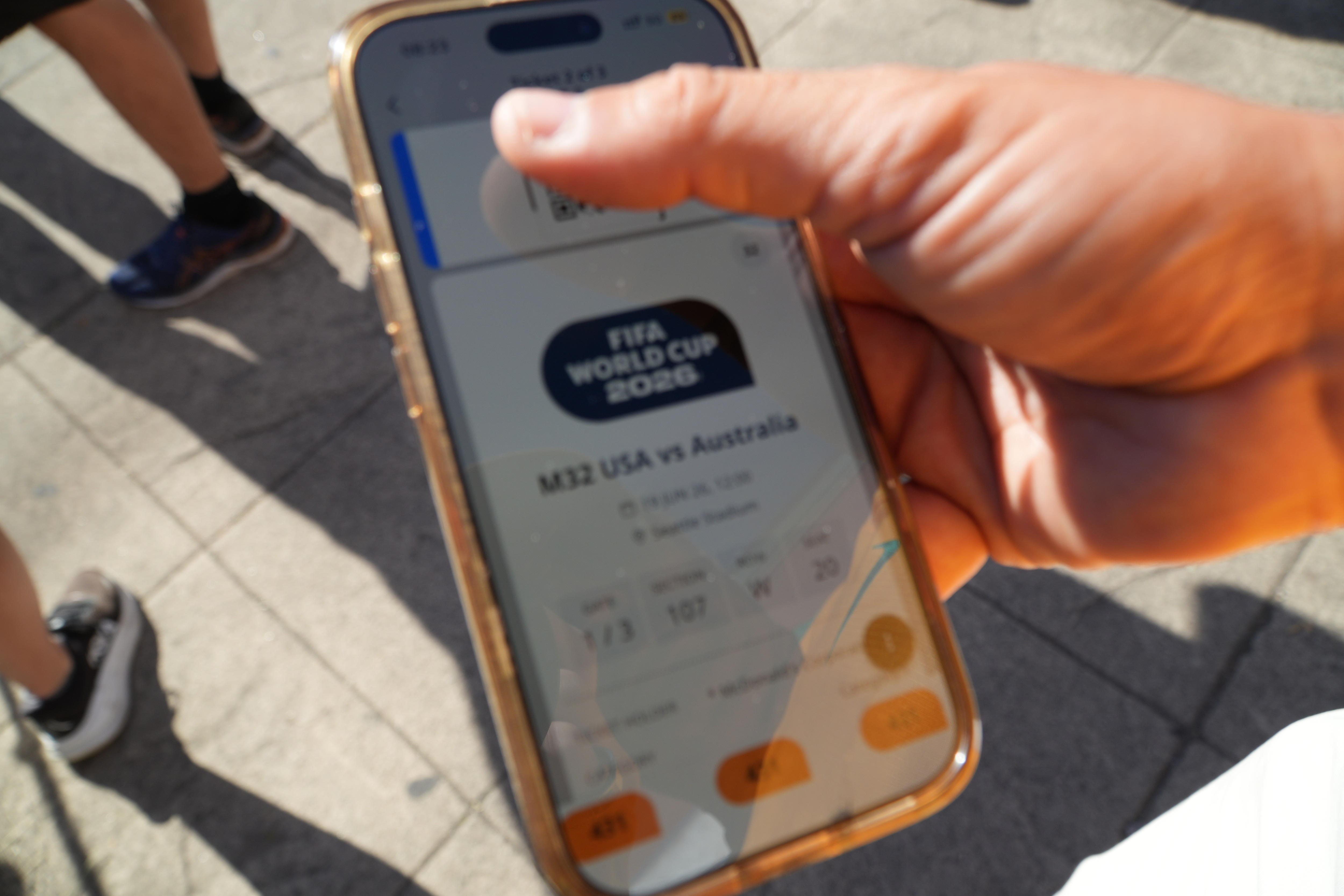 Photo of a mobile phone with a ticket displayed
