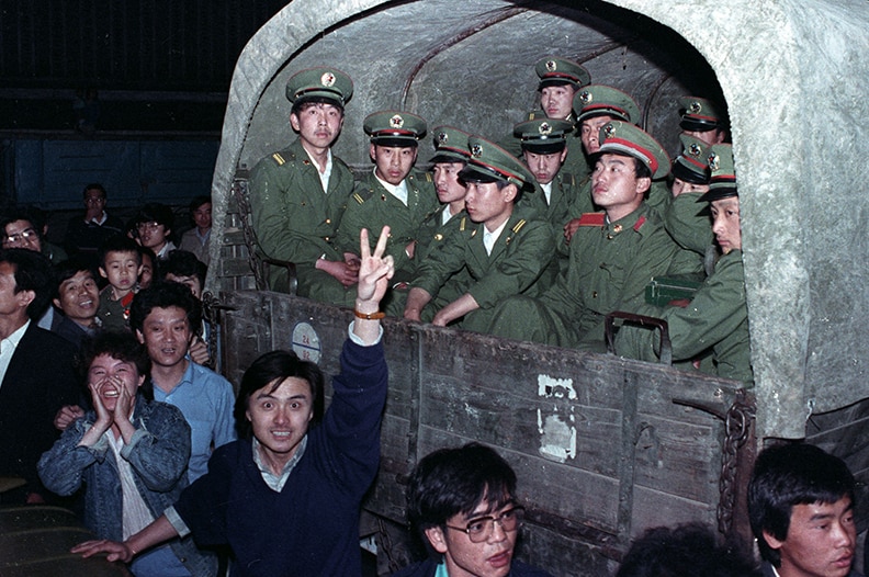 Residents of Beijing surround an army convoy of 4,000 soldiers to prevent them from continuing to Tiananmen Square.