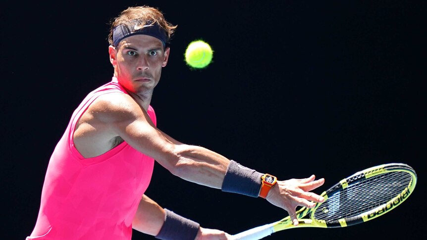 Rafael Nadal watches the tennis ball closely as he winds up a forehand at the Australian Open.
