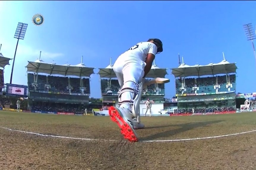 A batsman, as seen from the stump camera, looks back at the crease with his foot on or close to being behind the line
