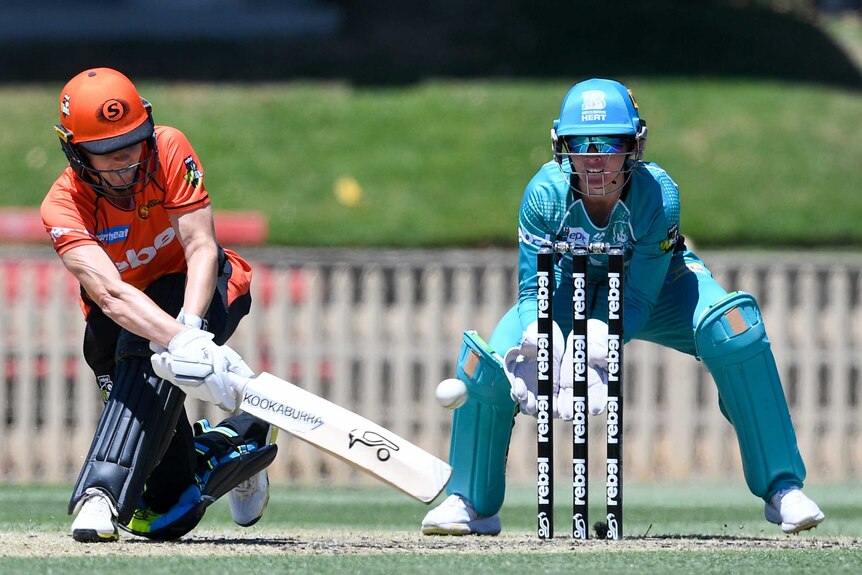 Nat Sciver attempts a sweep shot for the Scorchers against the Heat in their WBBL match at North Sydney Oval.