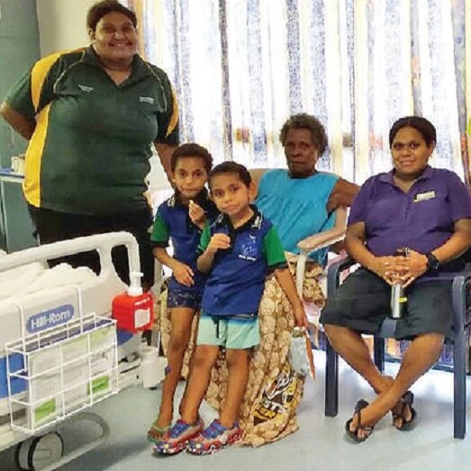 Rapia Komonde (sitting on left) with relatives on Thursday Island before being seized by ABF. (Supplied)