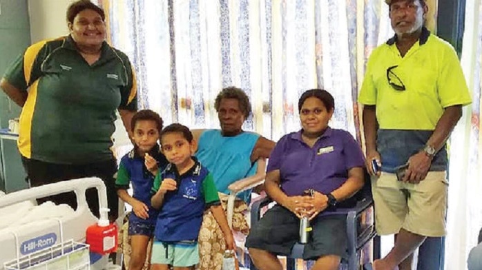 Rapia Komonde (sitting on left) with relatives on Thursday Island before being seized by ABF. (Supplied)