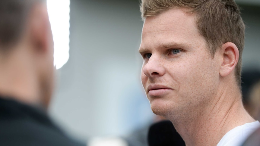 A close-up shot of Steve Smith. wearing casual clothes at a press conference.