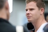 A close-up shot of Steve Smith. wearing casual clothes at a press conference.