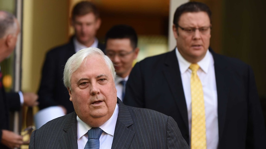 PUP leader Clive Palmer (C) and PUP Senator Glenn Lazarus (R) arrive for a press conference at Parliament House.