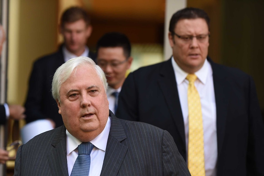 PUP leader Clive Palmer (C) and PUP Senator Glenn Lazarus (R) arrive for a press conference at Parliament House.