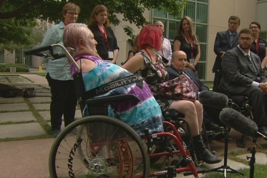 Monica McGhie is pictured strapped into a standard wheelchair.