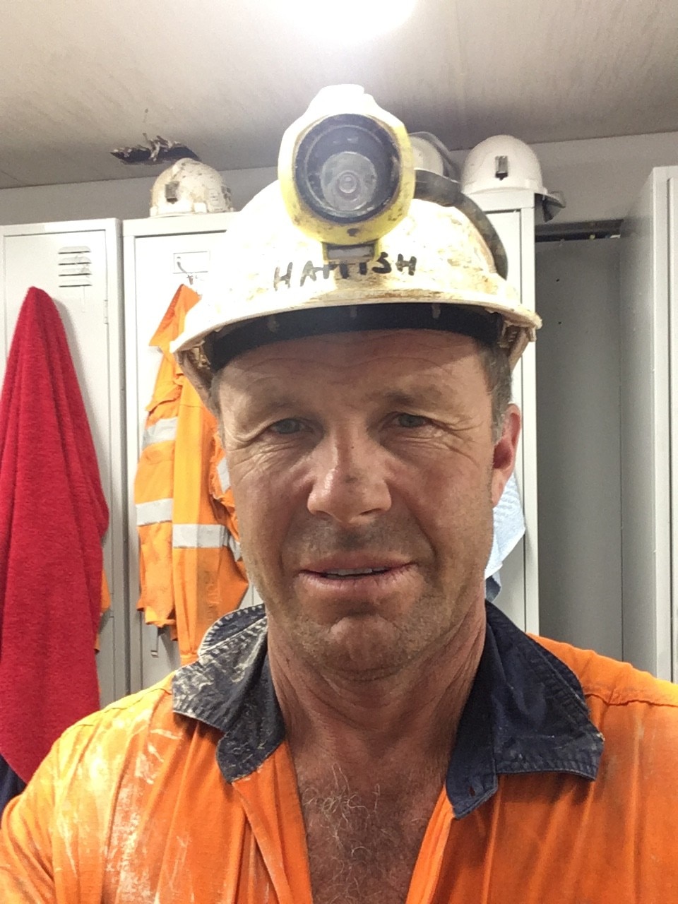 Close-up of a man wearing a hardhat.