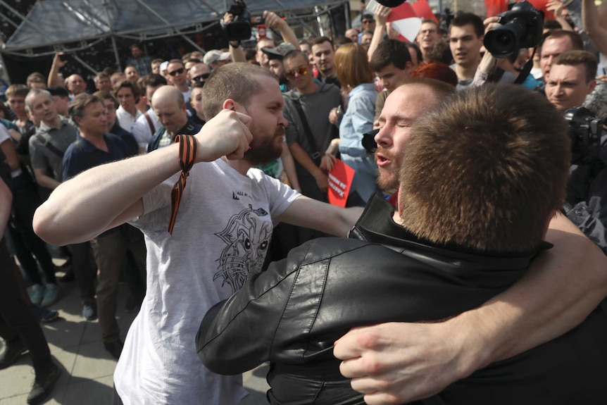 A fighter of National Liberation Movement clashes with protesters