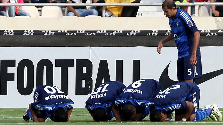 Saudi Al-Hilal players celebrate goal with prayer.