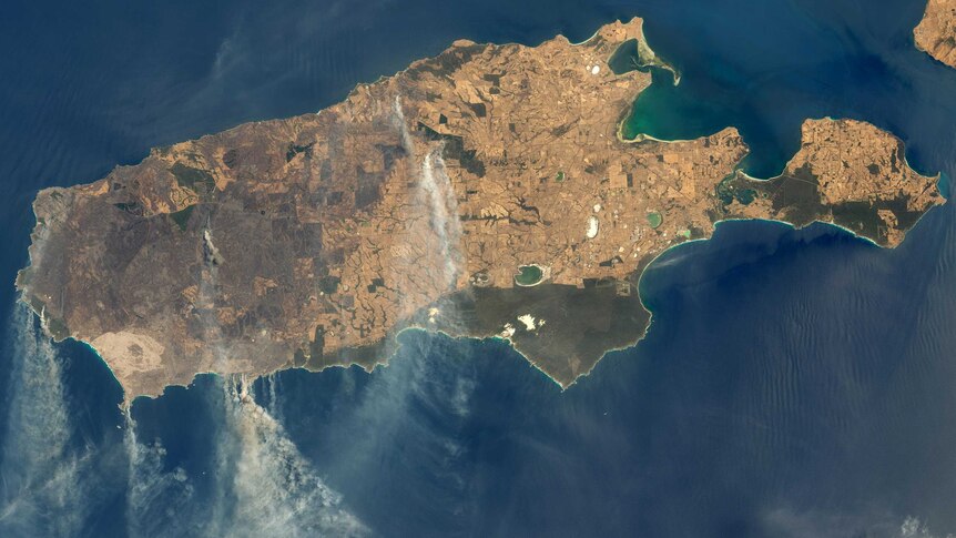 A satellite image of Kangaroo Island with smoke coming from various locations