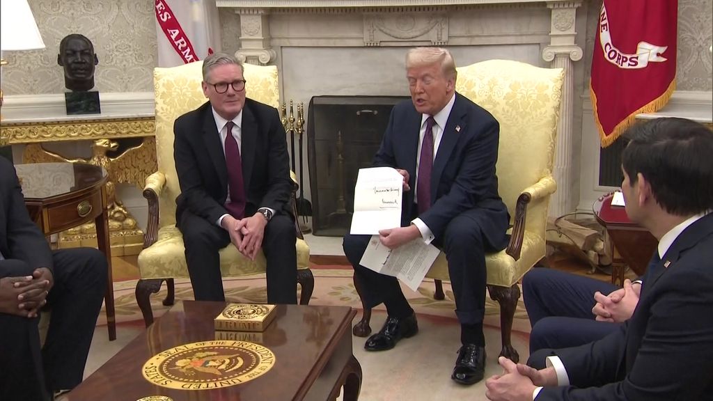 Donald Trump holds out a letter from King Charles with Keir Starmer