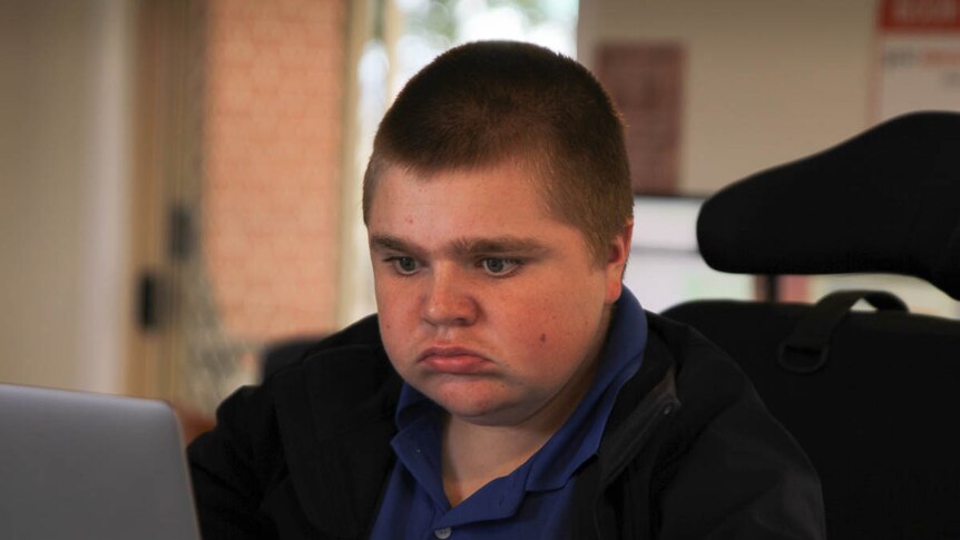 High school student Jack Wason in a wheelchair using a laptop