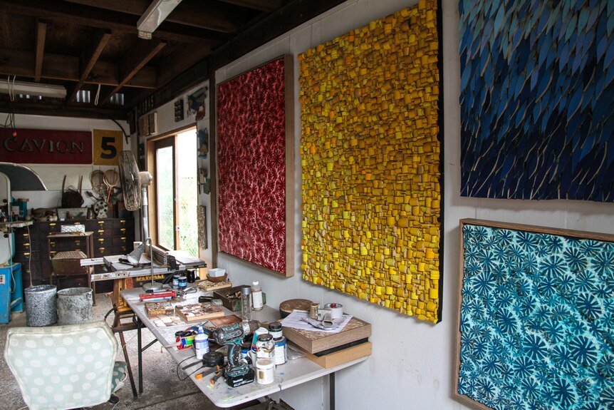 Artist studio with paintings hanging on the walls