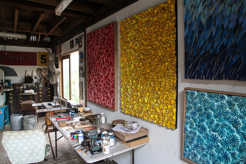 Artist's studio with paintings hanging on the walls
