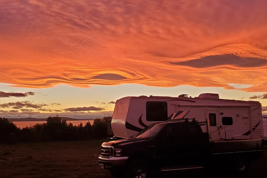 Orange, wave patterned clouds over a caravan in Southern Tasmania. 