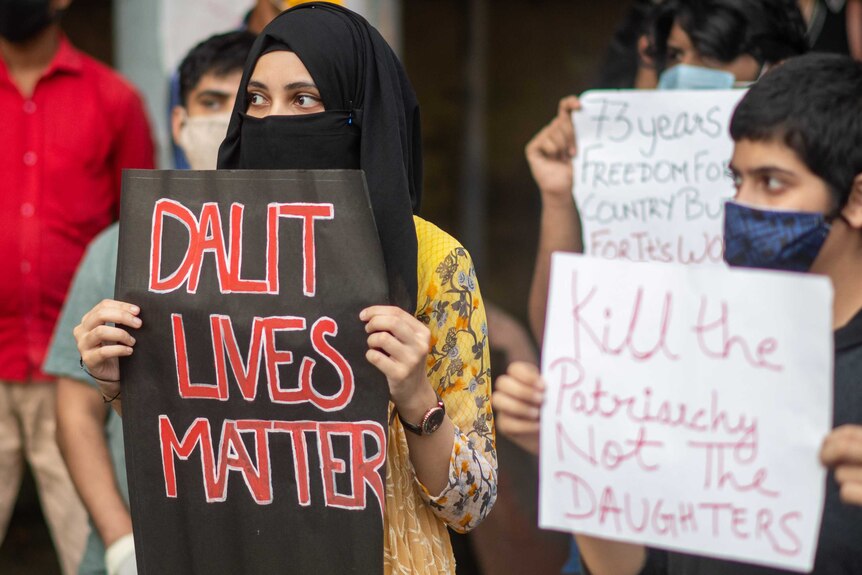 Protesters hold signs saying "Dalit Lives Matter" and "Kill the patriarchy not the daughters".