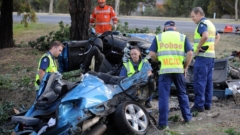 Police investigate the remains of a car involved in an accident that killed five people at Mill Park