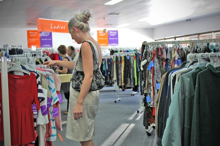 A woman browses the racks of clothing inside an Endeavour op-shop