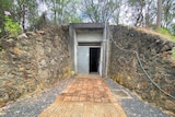 The doorway entrance to an underground bunker on a bush property.