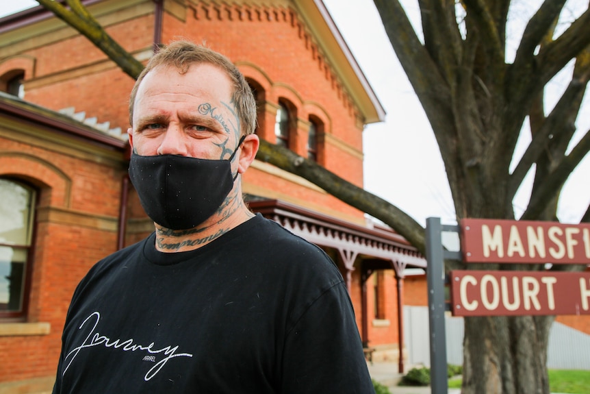 Brian Warton, wearing a black face mask, outside the Mansfield Court House.