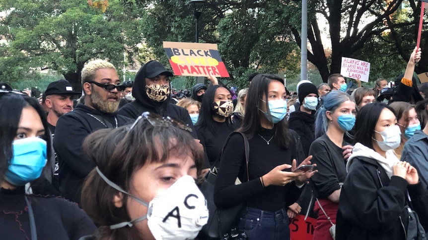 Marchers at the Sydney Black Lives Matter rally on June 6th, 2020, carrying placards and wearing masks