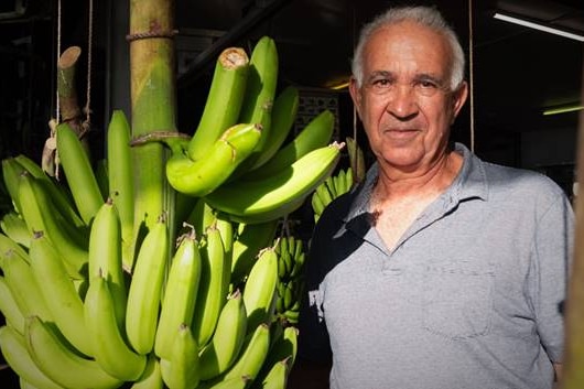 Frank Sciacca next to bananas.