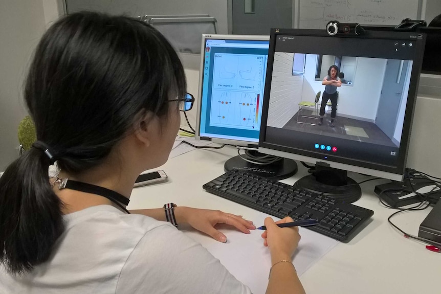 Deepti Aggarwal looking at information from smart socks on a computer screen.