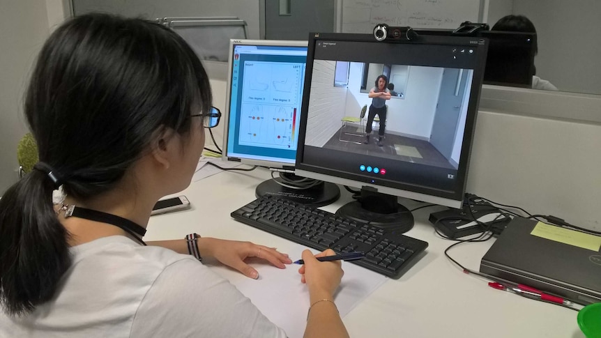 Deepti Aggarwal looking at information from smart socks on a computer screen.