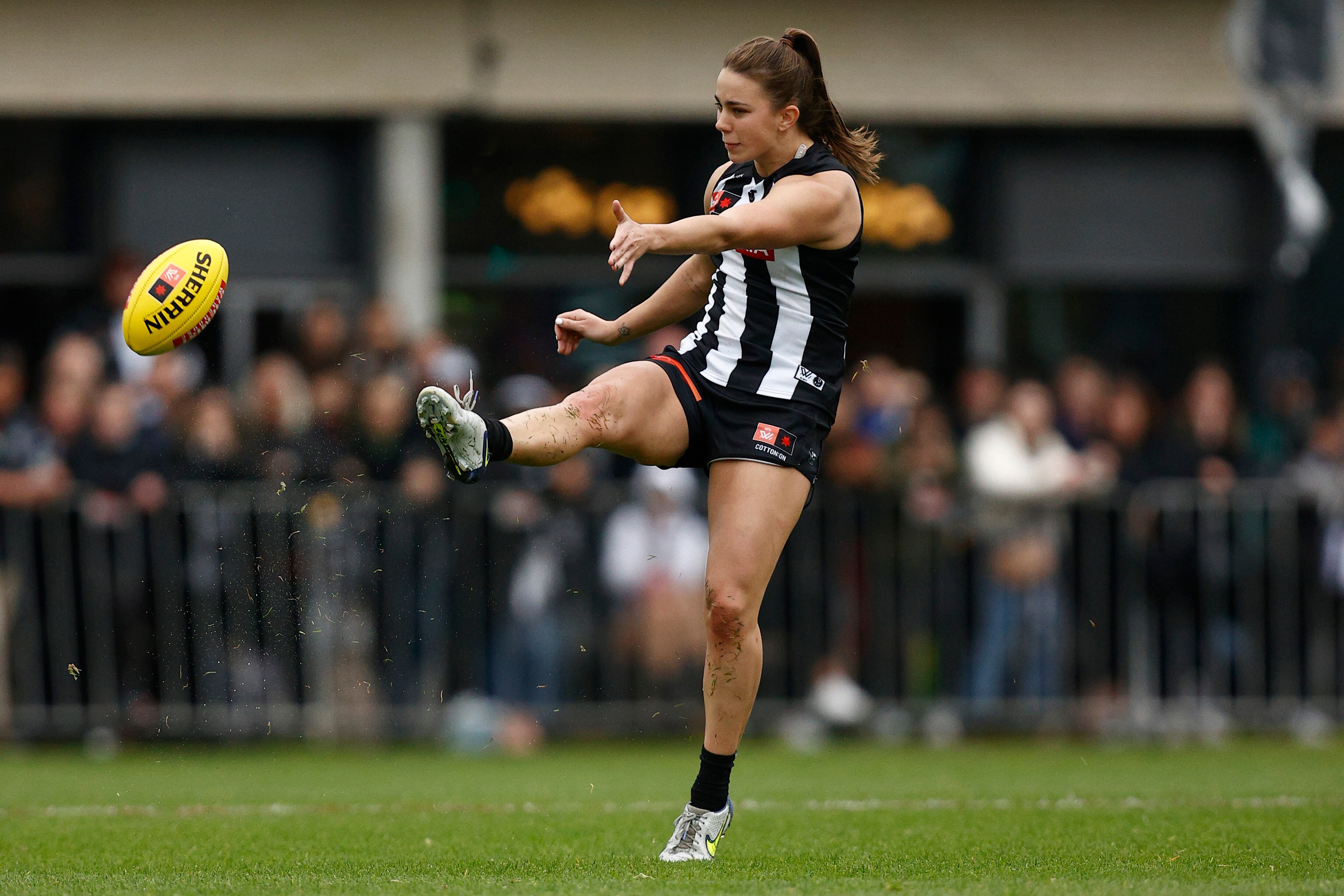 Chloe Mollow follows through after kicking the football