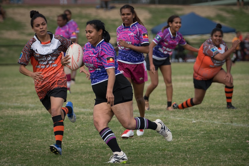 Eileen Byers runs the ball during the Lismore Aboriginal Rugby League Knockout carnival.