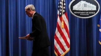 Special counsel Robert Muller walks from the podium