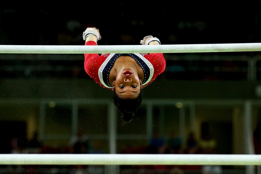 Gabrielle Douglas of the United States competes in the Women's Uneven Bars Final.