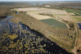 An aerial shot of old cane fields and farming land near a river