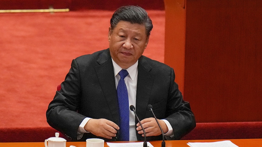 Xi Jinping sitting down before speaking at the Great Hall of the People. 