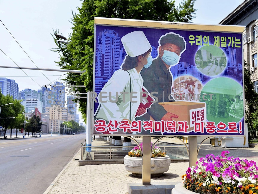 A sign depicting a scene of medical products transportation is displayed at the empty street