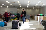 Looking through shop doors at the volunteers from Renmark op shop.